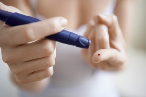 Person pricking finger to draw blood for testing