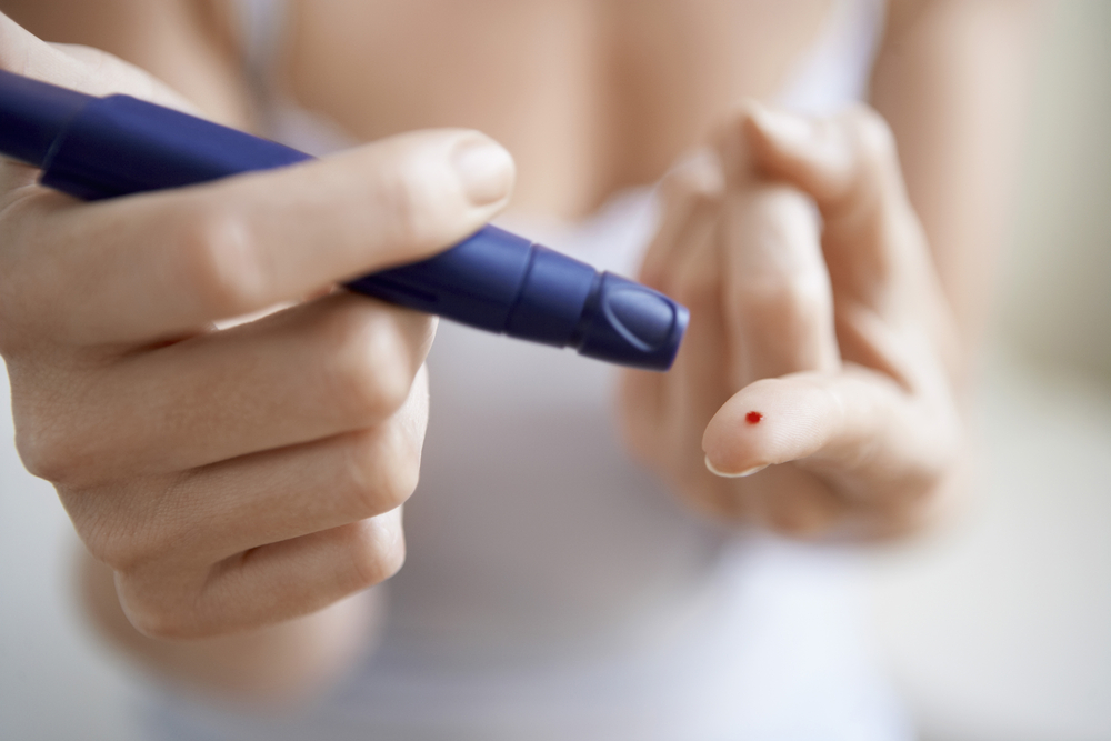 Person pricking finger to draw blood for testing